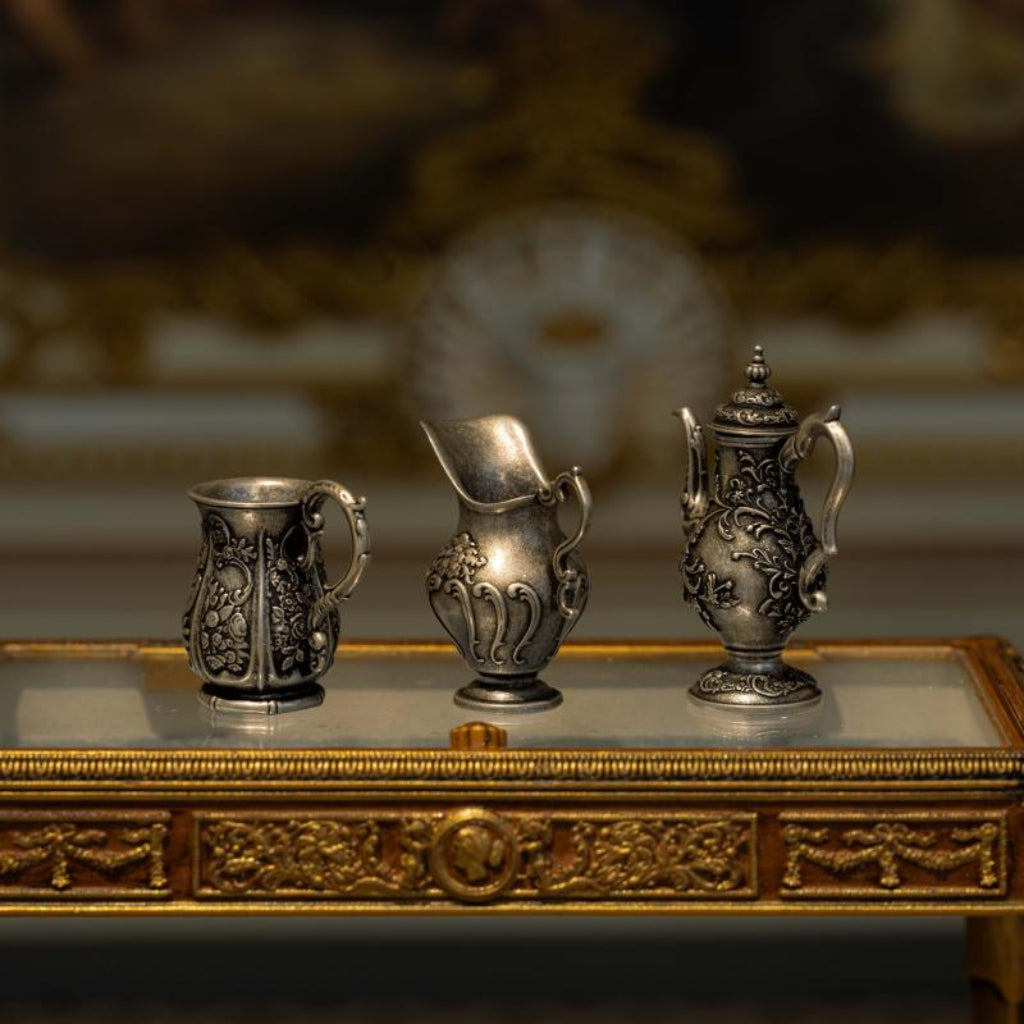 3-piece 1:12 scale miniature vintage silver tea set displayed in a dollhouse setting, elegant metal kettle creamer and cup decor