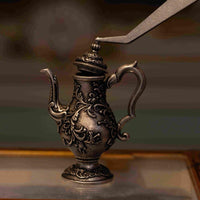 1:12 scale miniature vintage silver lidded tea kettle, part of a 3-piece dollhouse metal tea set with ornate lid detail