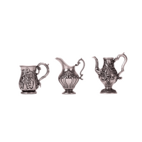 3-piece 1:12 scale miniature vintage silver tea set for dollhouse, including metal kettle, creamer and cup on white background