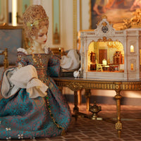 Detailed interior of Chinoiserie miniature room box with ornate European furniture - miniento