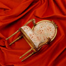Completed DIY 1:6 scale French armchair miniature displayed on red silk fabric, elegant dollhouse furniture craft for desktop decor
