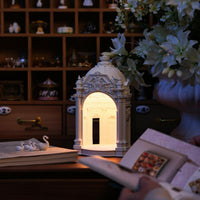 Starry Dream Prelude European classical resin table lamp displayed on a bookshelf next to vintage books, elegant home decor piece